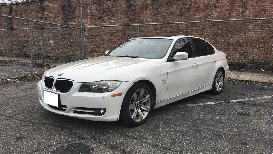 White BMW 328i sedan parked on the lot (AI placeholder photo)