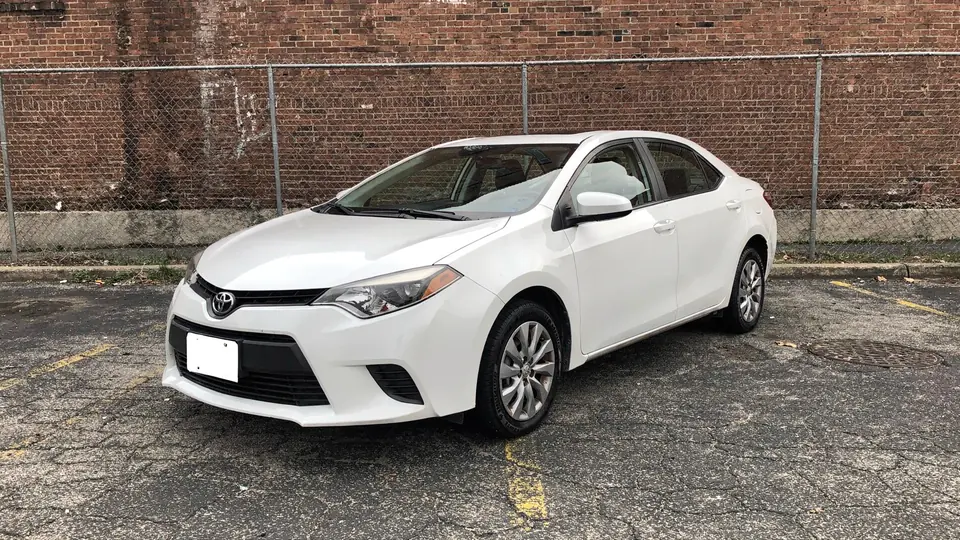 White Toyota Corolla S sedan parked on the lot (AI placeholder photo)