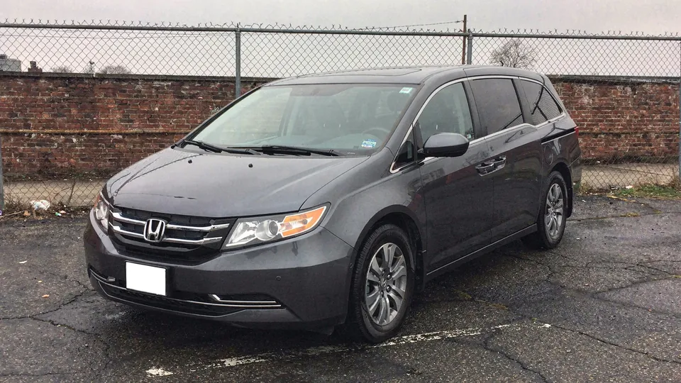 Dark grey Honda Odyssey minivan parked on the lot (AI placeholder photo)