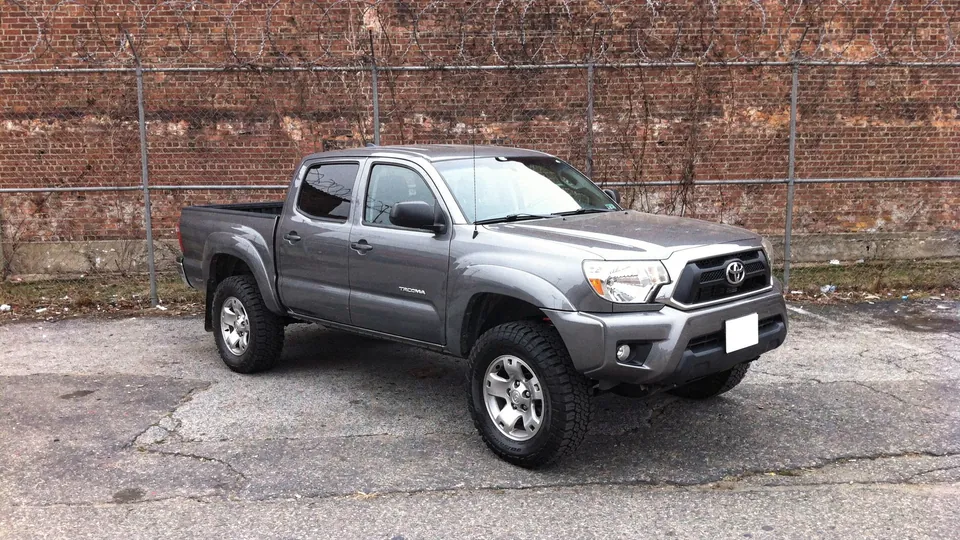 Grey Toyota Tacoma TRD Off-Road pickup parked on the lot (AI placeholder photo)