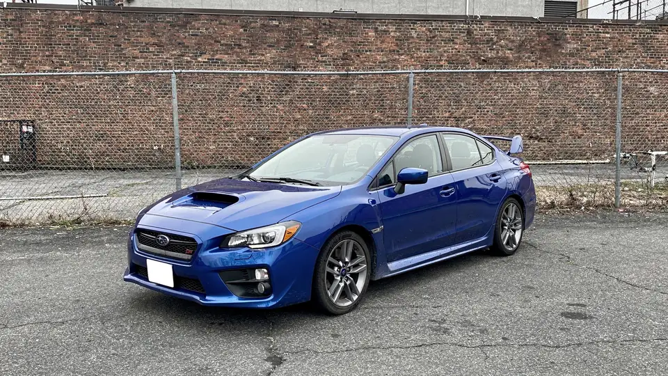 Blue Subaru WRX sedan parked on the lot (AI placeholder photo)